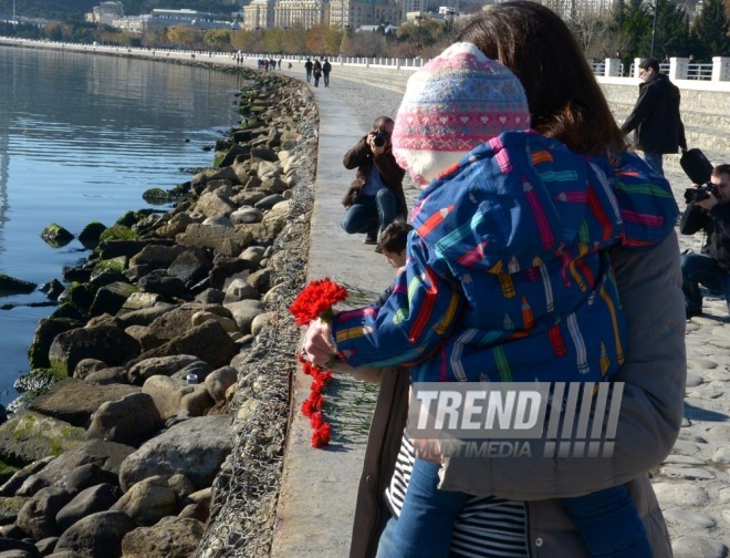 Baku residents bringing flowers to Seaside Boulevard to honor missing oil workers.  Azerbaijan, Dec.07, 2015